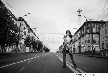 A girl standing in the middle of the roadway. Street urban style. 49750532