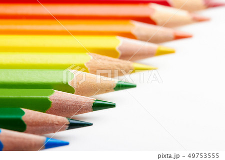 Set of multicoloured pencils lying on white table Set of multicoloured pencils lying on white table 49753555