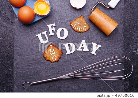 Text UFO day and cookies in the form of a flying saucer and an alien 49760016