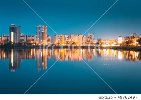 Night View Of Urban Residential Area Overlooks To City Lake Or River And Park In Evening 49762497
