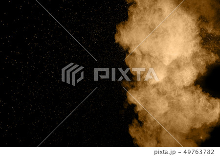 Abstract brown dust explosion on black blackground Abstract brown dust explosion on black blackground 49763782