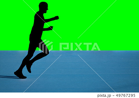 Fast marathon runner silhouette with green background 49767295