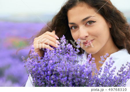 beautiful woman face with lavender flower 49768310