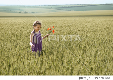 girl with red tulip flowers posing in the wheat girl with red tulip flowers posing in the wheat 49770188
