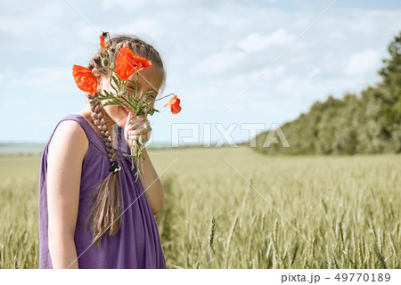 girl with red tulip flowers posing in the wheat girl with red tulip flowers posing in the wheat 49770189