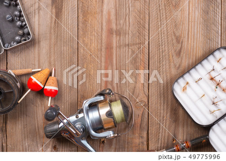 Fishing tackle on wooden background. Accesories for fishing with copyspace. 49775996