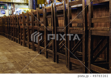 wooden chairs at the bar in the pub 49783161
