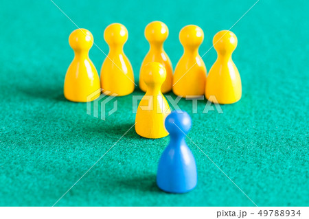 yellow pawns with leader in front of one blue pawn 49788934
