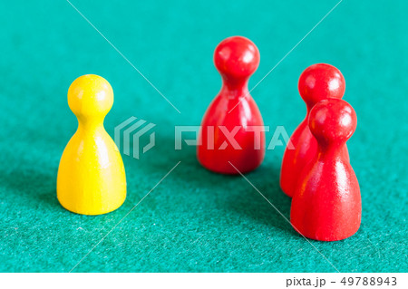 one yellow pawn in front of three red pawns one yellow pawn in front of three red pawns 49788943