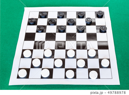 checkers on black and white checkered sheet board 49788978