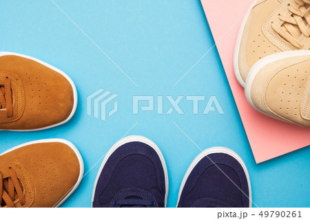 Three pair of sneakers on colored background Three pair of sneakers on colored background 49790261