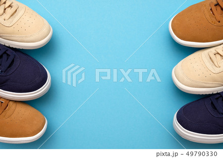 Pair of new sneakers on blue background Pair of new sneakers on blue background 49790330