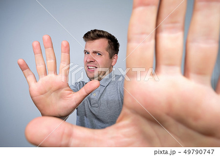 man shows refusal gesture saying leave me in piece. 49790747