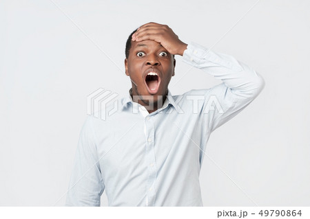 Shocked black male says wow, looks bugged eyes and rounded mouth, being amazed 49790864