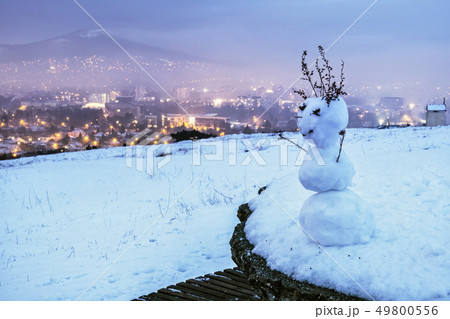 Snowman and Nitra city, Slovakia, evening photo 49800556