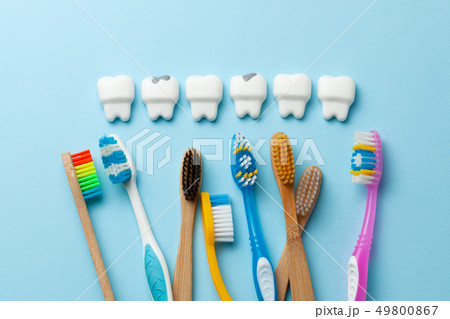 Healthy white teeth and tooth with caries is sad on blue background and Toothbrush. 49800867