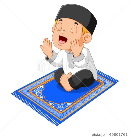 the boy is praying on the blue prayer rug 49801761