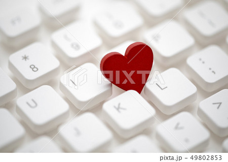 Small red heart on computer keyboard 49802853