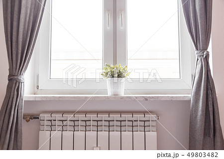 Window and radiator in room 49803482