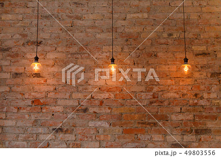Three retro style light bulb on brick wall background 49803556