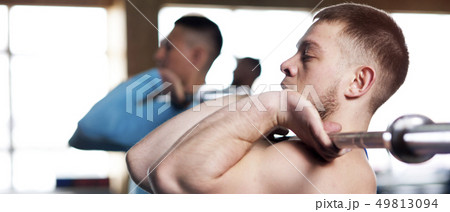 Young People in Gym Training With Barbells Young People in Gym Training With Barbells 49813094