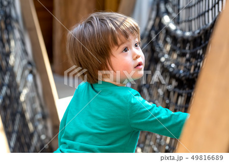Toddler boy playing at a playground Toddler boy playing at a playground 49816689
