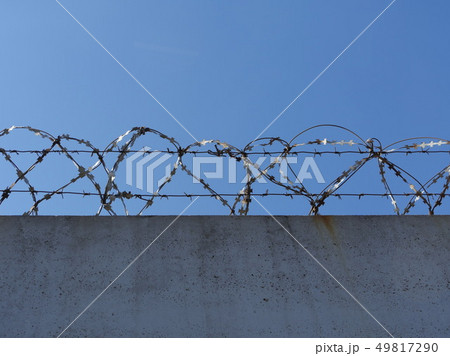 concrete wall with barbed wire 49817290