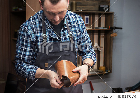 Concept of handmade craft production of leather goods. Concept of handmade craft production of leather goods. 49818074