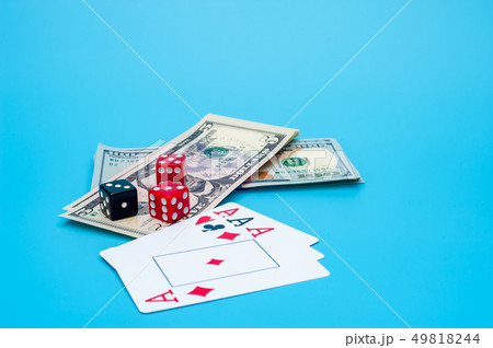 Playing Cards, Gaming Dices and Dollar Bills Stack on Background Playing Cards, Gaming Dices and Dollar Bills Stack on Background 49818244