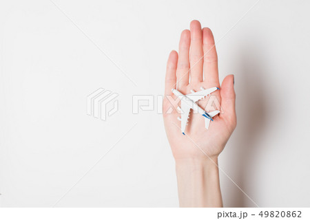 Airliner on the female palm on a light background. Airliner on the female palm on a light background. 49820862