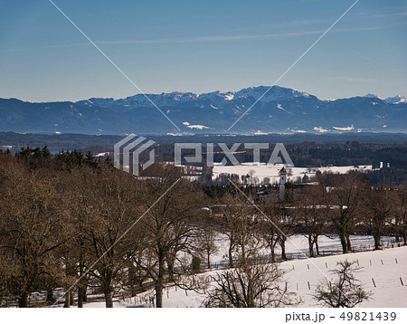 Trees and church in front of an alpine backdrop Trees and church in front of an alpine backdrop 49821439