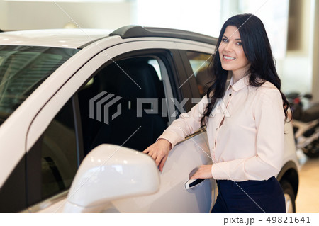 Portrait of happy customer buying new car and examines the car 49821641