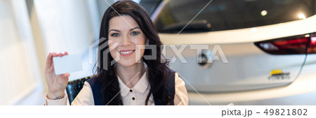 Portrait of stylish insurance agent holding a card 49821802