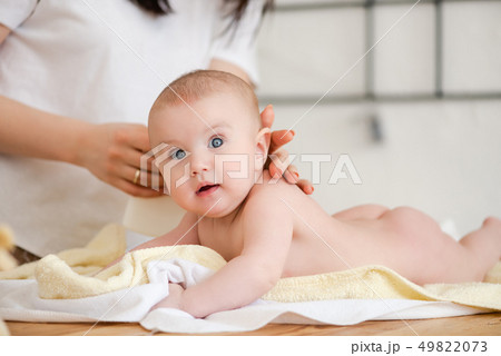 Happy baby girl during massage by mother 49822073