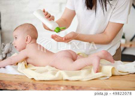 Mother put oil lotion at baby skin Mother put oil lotion at baby skin 49822078