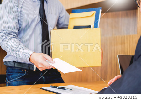 Hand of a businessman hands over a resignation 49828315