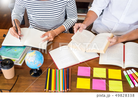 Young students classmates help friend catching up Young students classmates help friend catching up 49828338