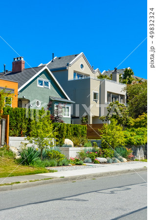 Modern residential houses on the street with landscaped front yards on terraces. Modern residential houses on the street with landscaped front yards on terraces. 49832324
