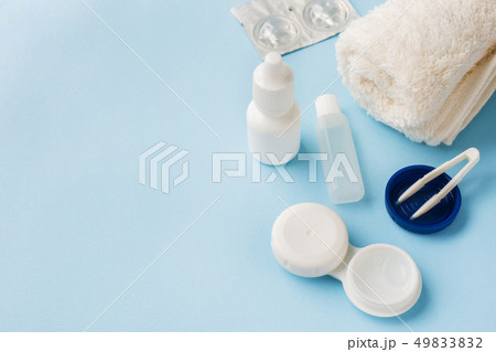 Contact lenses, tweezers and a container Contact lenses, tweezers and a container 49833832