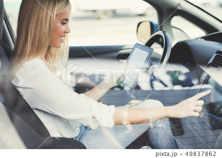 A young girl presses buttons on electric vehicle A young girl presses buttons on electric vehicle 49837862