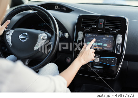 A young girl presses buttons on electric vehicle A young girl presses buttons on electric vehicle 49837872