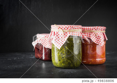 Various types of canned sauce for serving to meat, adjika from tomato, sorrel, tkemali from plum. Various types of canned sauce for serving to meat, adjika from tomato, sorrel, tkemali from plum. 49838806
