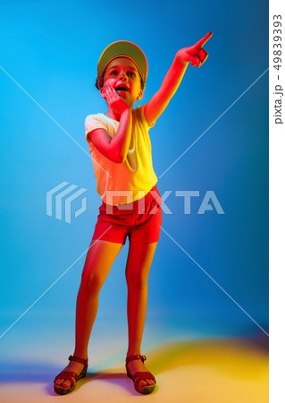 Beautiful teen girl looking suprised isolated on blue Beautiful teen girl looking suprised isolated on blue 49839393