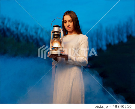 Mysterious mystical girl in a dark night forest Mysterious mystical girl in a dark night forest 49840210