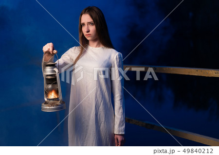Mysterious mystical girl in a dark night forest Mysterious mystical girl in a dark night forest 49840212