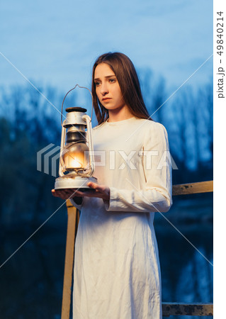 Mysterious mystical girl in a dark night forest Mysterious mystical girl in a dark night forest 49840214