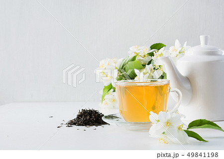 Cup of green jasmin tea white jasmine flowers, teapot. Teatime. Copy space. Cup of green jasmin tea white jasmine flowers, teapot. Teatime. Copy space. 49841198