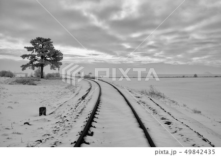 Single railway track in winter landscape. Single railway track in winter landscape. 49842435