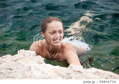 Portrait woman relax luxury pool villa, infinity sea view. Rest and travel. On a Sunny summer day. 49844734
