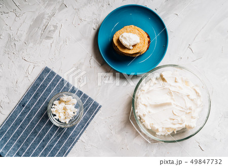 Bowl of cream cheese homemade in glass plate with pancakes and cottage cheese top view healthy food Bowl of cream cheese homemade in glass plate with pancakes and cottage cheese top view healthy food 49847732